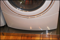 Drip pan under washer to prevent water damage and mold growth